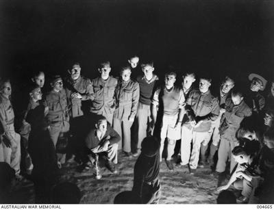 GAZA, PALESTINE. TROOPS PLAY A GAME OF TWO UP AT NIGHT